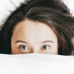 young-woman-in-a-bed-with-open-eyes